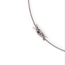 Load image into Gallery viewer, Stainless Steel XOX plaque on a stainless steel wire necklace.  The jewelry is set on a white background. Ouwitting injustice with love for humanity.